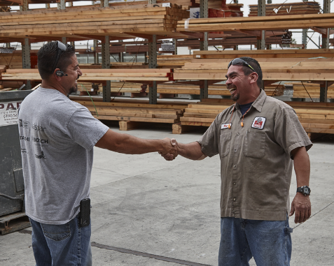 Ganahl employee and customer shaking hands in the lumber yard