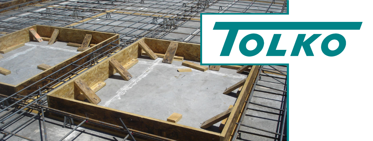 Tolko logo on top of a concrete form with metal and wood supports.