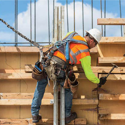 A construction worker using a harness at a jobsite. 