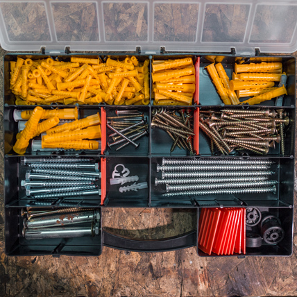 A tool box full of different fasteners. 