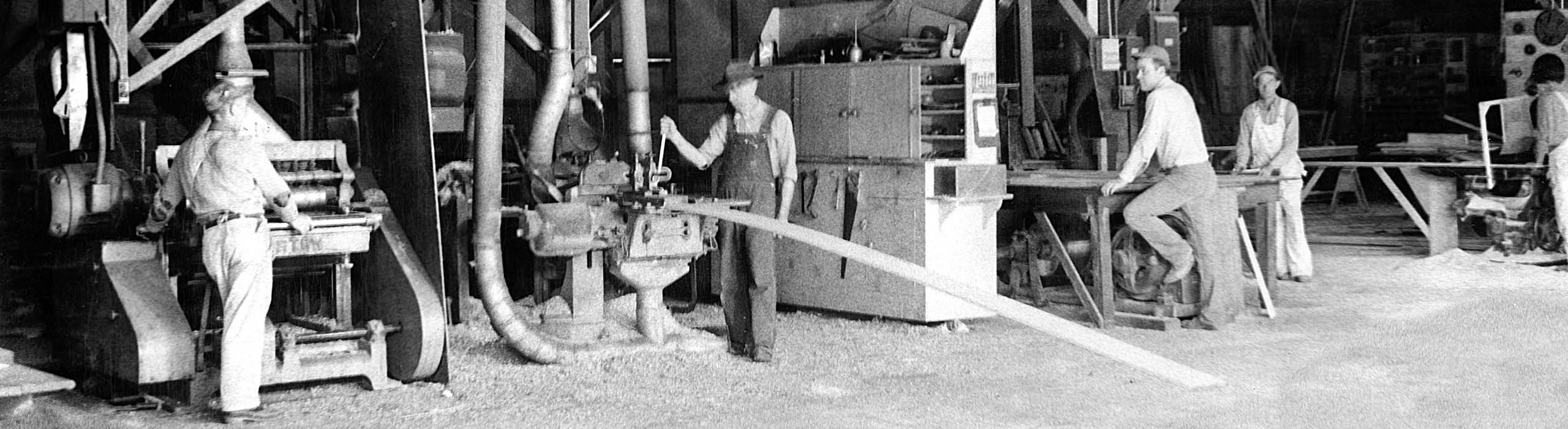 Old black and white photo of Ganahl workers in a millshop.