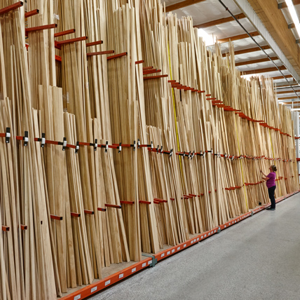 Vertical racks of hardwood lumber. 