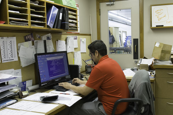 A Ganahl lumber employee working on a computer. 